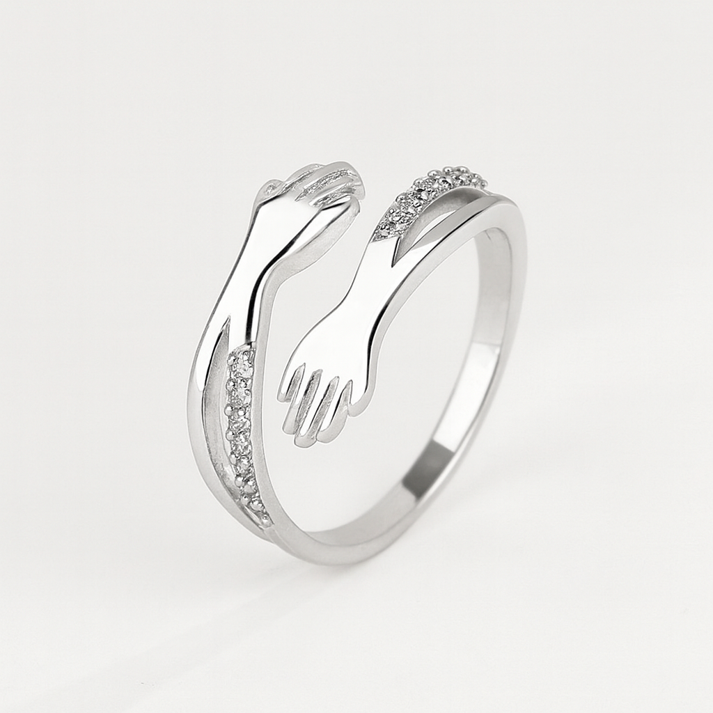 Silver ring with unique hand design, featuring sparkling diamond accents. Elegant jewelry piece, perfect for fashion-forward style and gift ideas.