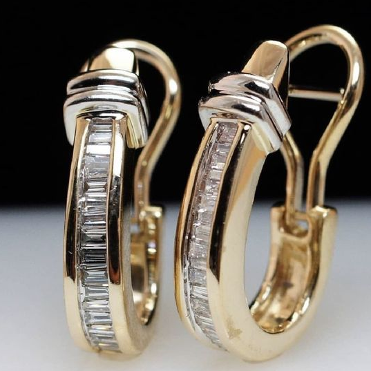 Gold hoop earrings with baguette-cut diamonds, featuring a sleek, modern design. Luxurious jewelry, perfect for elegant fashion statements.