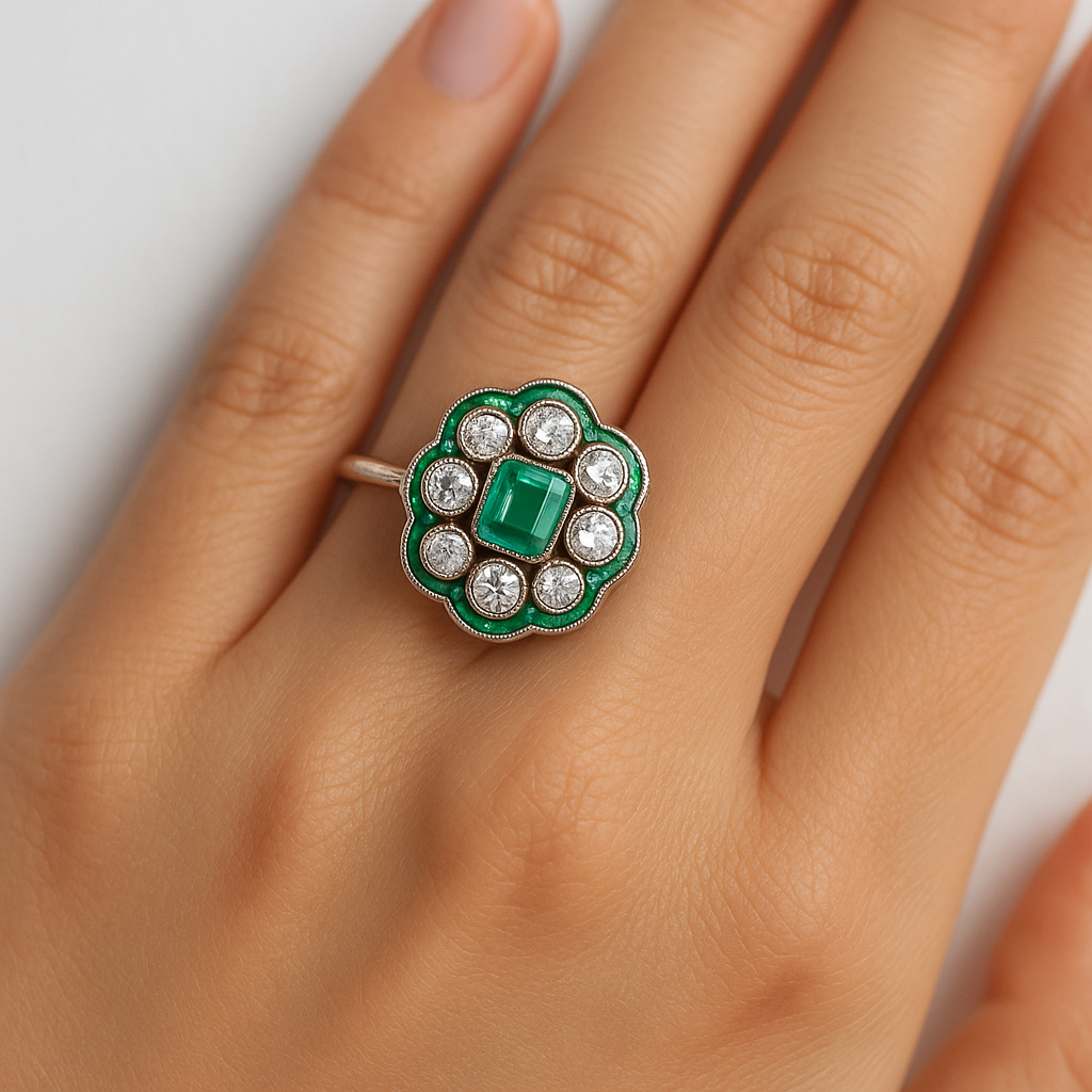 Elegant emerald and diamond ring on hand, featuring a central green gemstone surrounded by sparkling diamonds, showcasing luxury jewelry design.