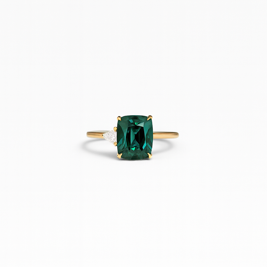 Emerald green gemstone ring with gold band and diamond accent, elegant jewelry, luxury accessory, perfect for engagement or special occasions.