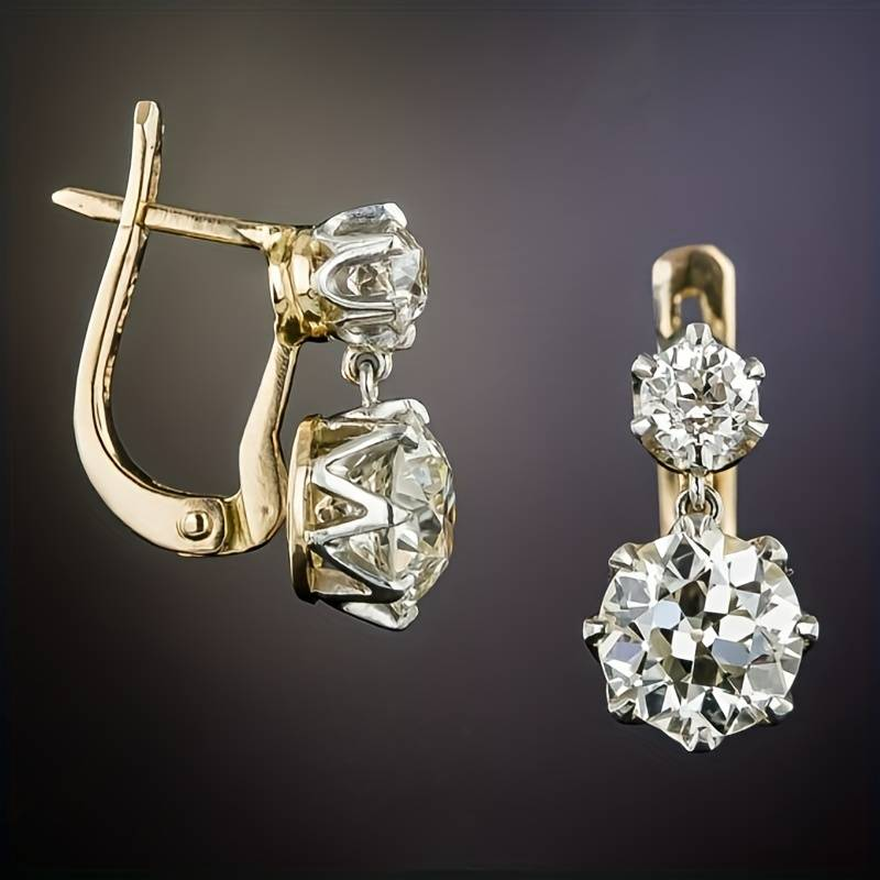 Gold diamond drop earrings with round brilliant-cut stones, elegant jewelry design, luxury accessories, sparkling gemstones, fashion statement.