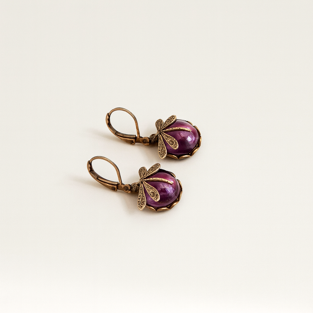 Vintage bronze earrings with purple gemstone and intricate leaf design, elegant jewelry accessory, antique style, fashion statement piece.