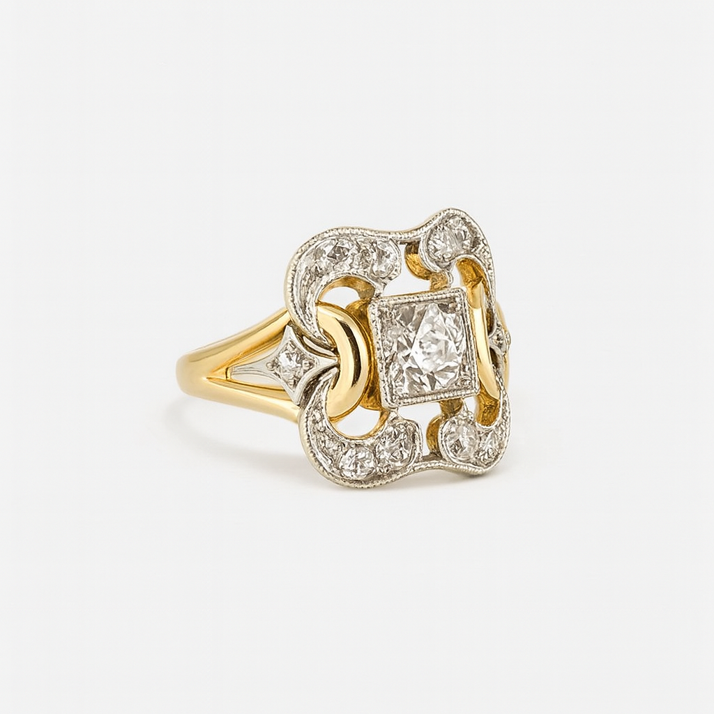 Gold ring with diamond accents on a light gray background