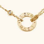Gold Cartier Love necklace with diamond accents, featuring iconic screw motif and engraved "Love" design. Luxury jewelry, elegant fashion accessory.