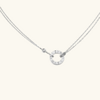 Silver double-chain necklace with circular pendant engraved with "LIVE LOVE." Elegant jewelry piece, minimalist design, perfect for everyday wear.