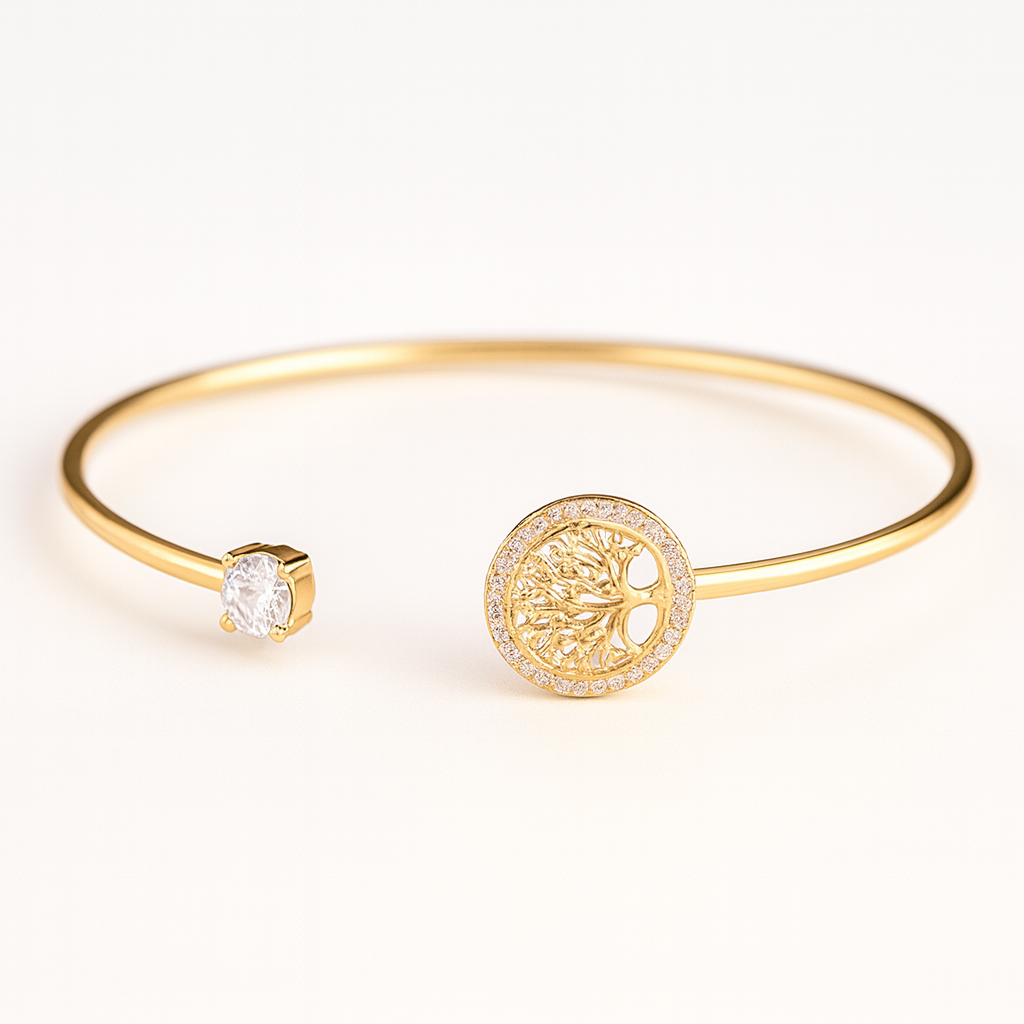 Gold bangle bracelet with a tree of life charm and a sparkling diamond accent, elegant jewelry piece, perfect for fashion and style enthusiasts.