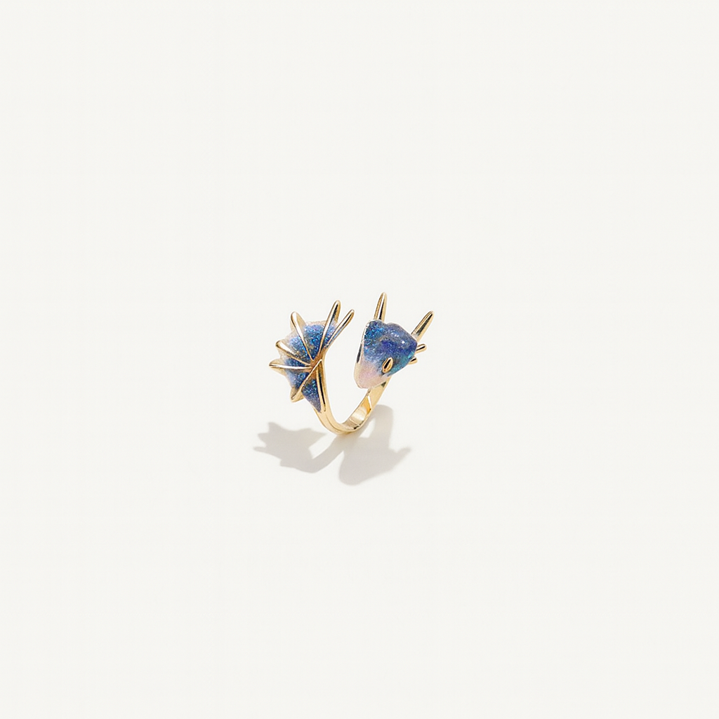 Gold ring with two blue gemstone accents, featuring unique geometric designs. Elegant jewelry piece, perfect for fashion accessories and style enthusiasts.