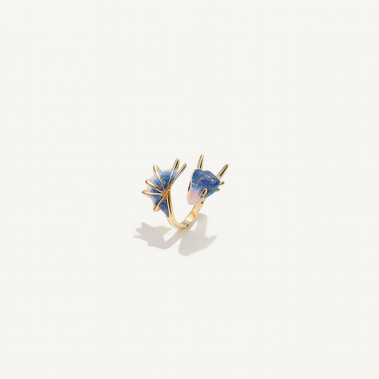 Gold ring with two blue gemstone accents, featuring unique geometric designs. Elegant jewelry piece, perfect for fashion accessories and style enthusiasts.