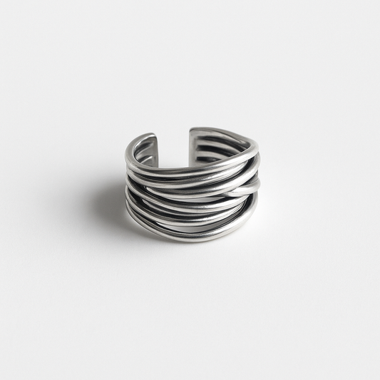 Silver multi-band open cuff ring on white background, minimalist jewelry design, modern fashion accessory, unisex statement piece.