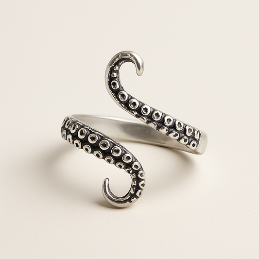 Silver octopus tentacle ring on a light beige background