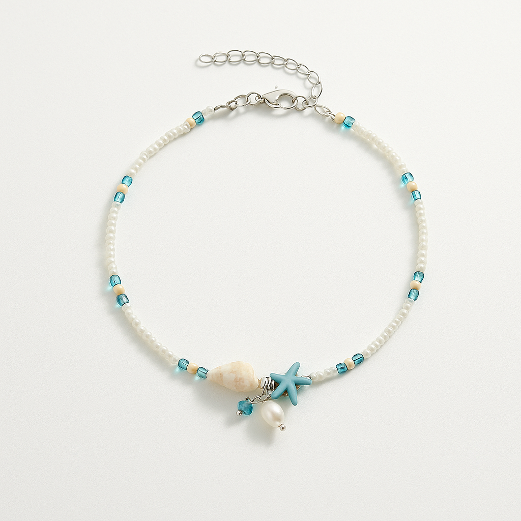 Beach-themed anklet with turquoise beads, seashell, starfish charm, and pearl on a silver chain. Coastal jewelry, summer accessory, boho style.