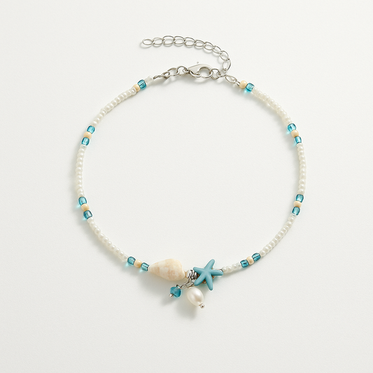 Beaded bracelet with starfish and shell charm on a light gray background