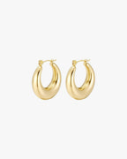 Gold hoop earrings with a chunky design on a white background, showcasing elegant, minimalist jewelry style. Perfect for fashion accessories.