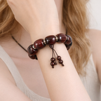 Brown beaded bracelet on a wrist with a blurred background