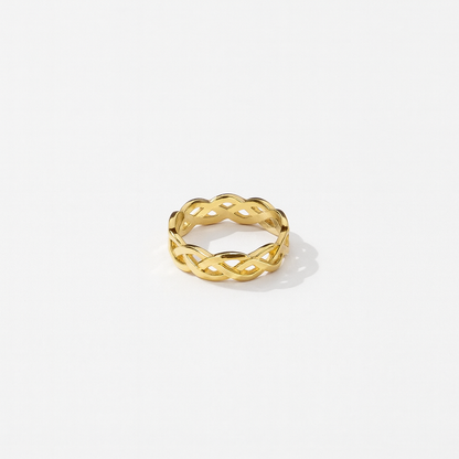 Gold ring with a braided design on a white background