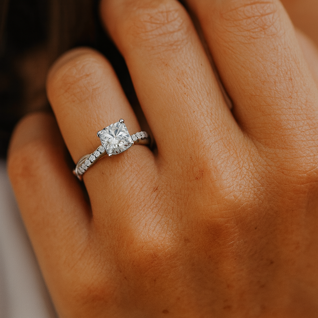 Diamond ring on a person's finger with a blurred background