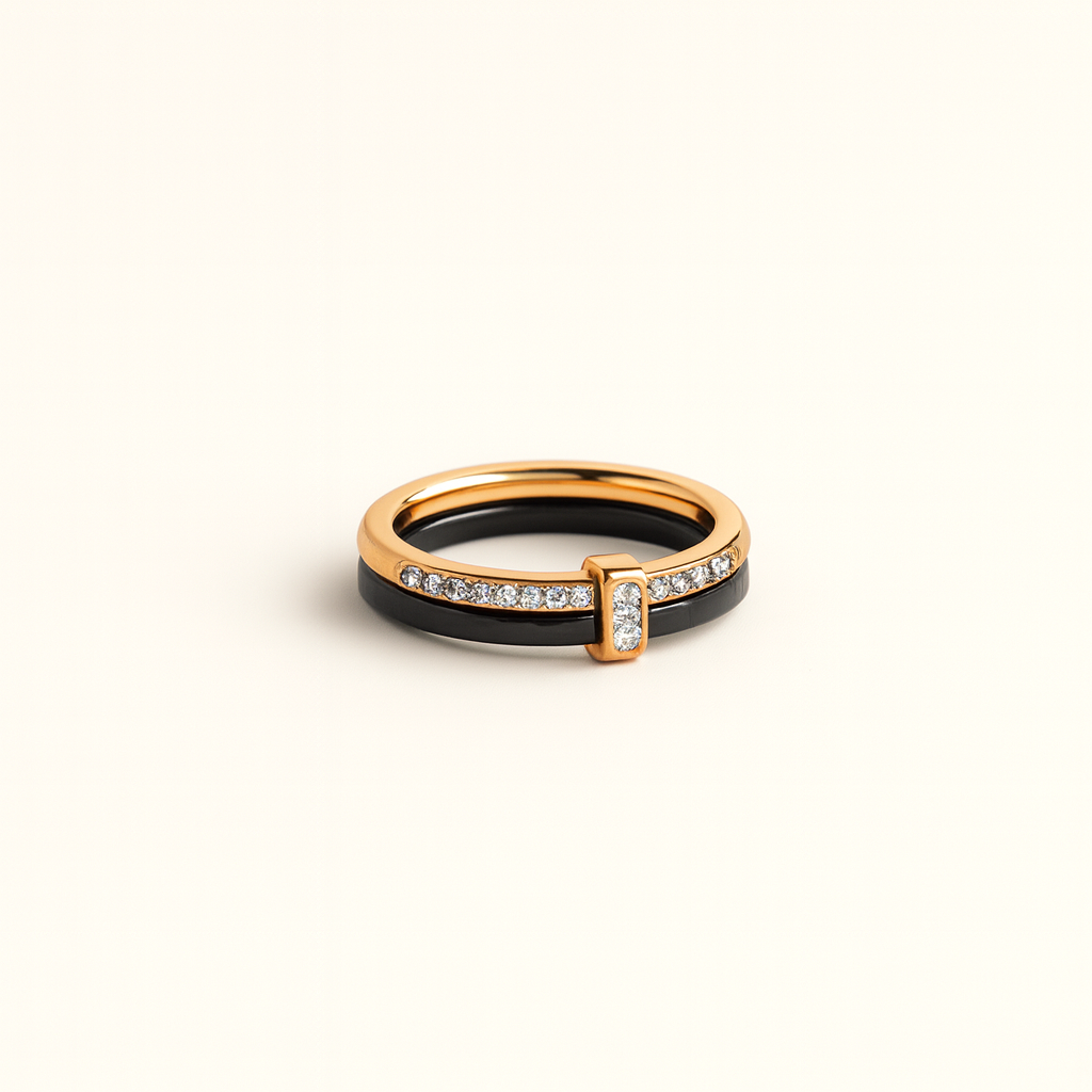 Gold and black ring with diamond accents on a beige background