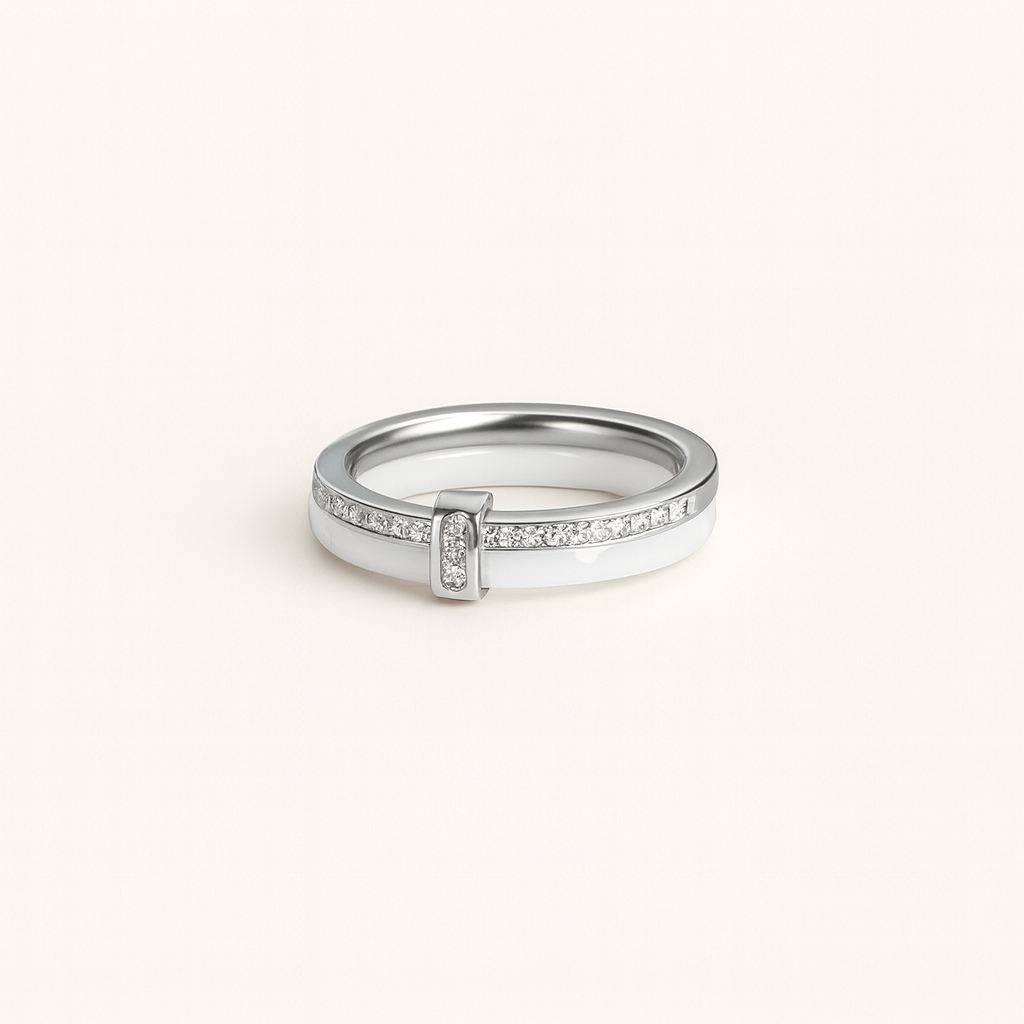 Silver ring with small diamonds on a light beige background