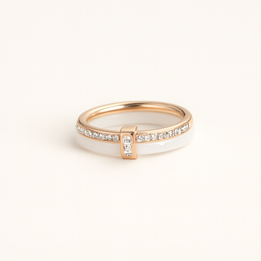 Rose gold and white ceramic ring with embedded diamonds on a light beige background