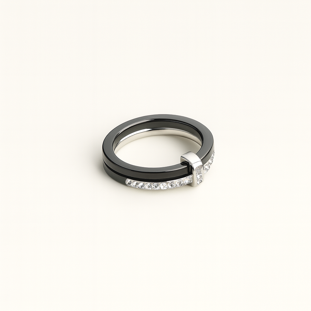 Two rings, one black and one silver with diamonds, on a white background