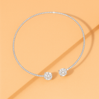 Elegant diamond choker necklace with two large round diamonds on a peach background. Luxurious jewelry, sparkling gemstones, fashion accessory.