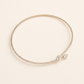 Elegant diamond tennis bracelet with a minimalist design, featuring a delicate gold band and sparkling round-cut diamonds, perfect for luxury jewelry lovers.