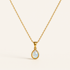 Gold chain necklace with a teardrop opal pendant, showcasing iridescent colors. Elegant jewelry piece, perfect for fashion and style enthusiasts.