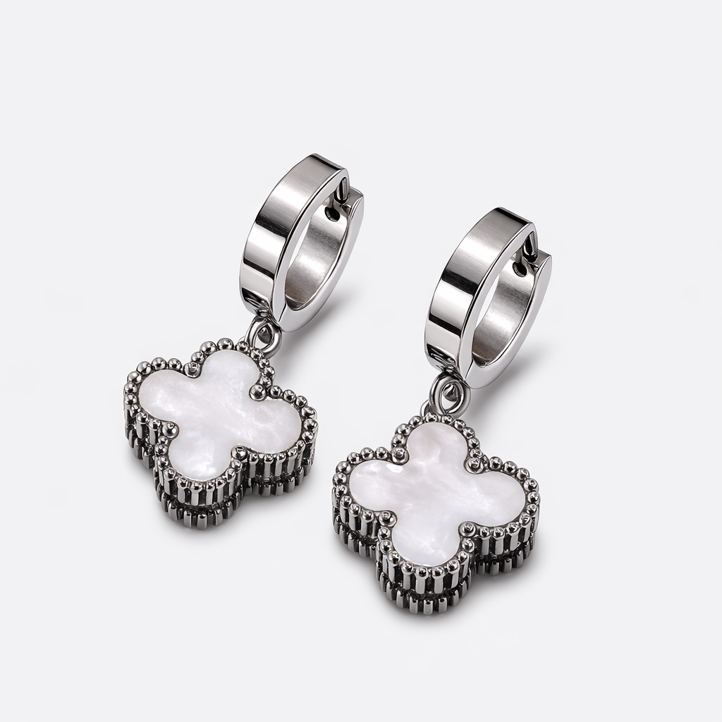 Silver hoop earrings with floral designs on a white background
