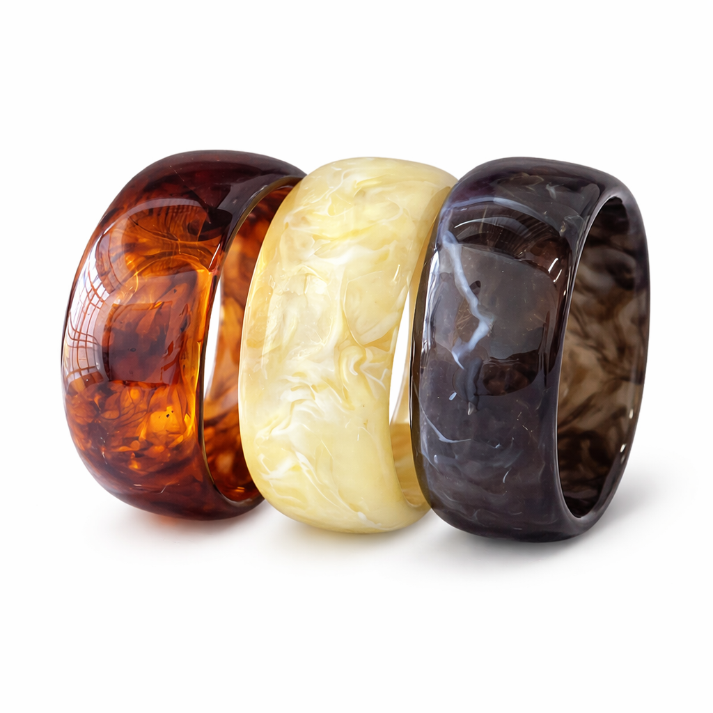 Three amber rings of different colors on a white background