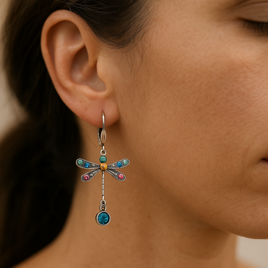 Close-up of a woman wearing a colorful dragonfly-shaped earring.