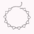 Silver necklace with heart-shaped links on a white background