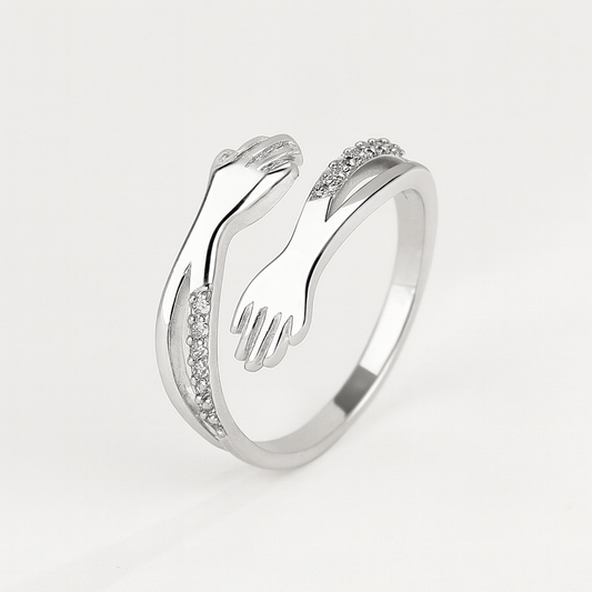 Silver ring with unique hand design, featuring sparkling diamond accents. Elegant jewelry piece, perfect for fashion-forward style and gift ideas.
