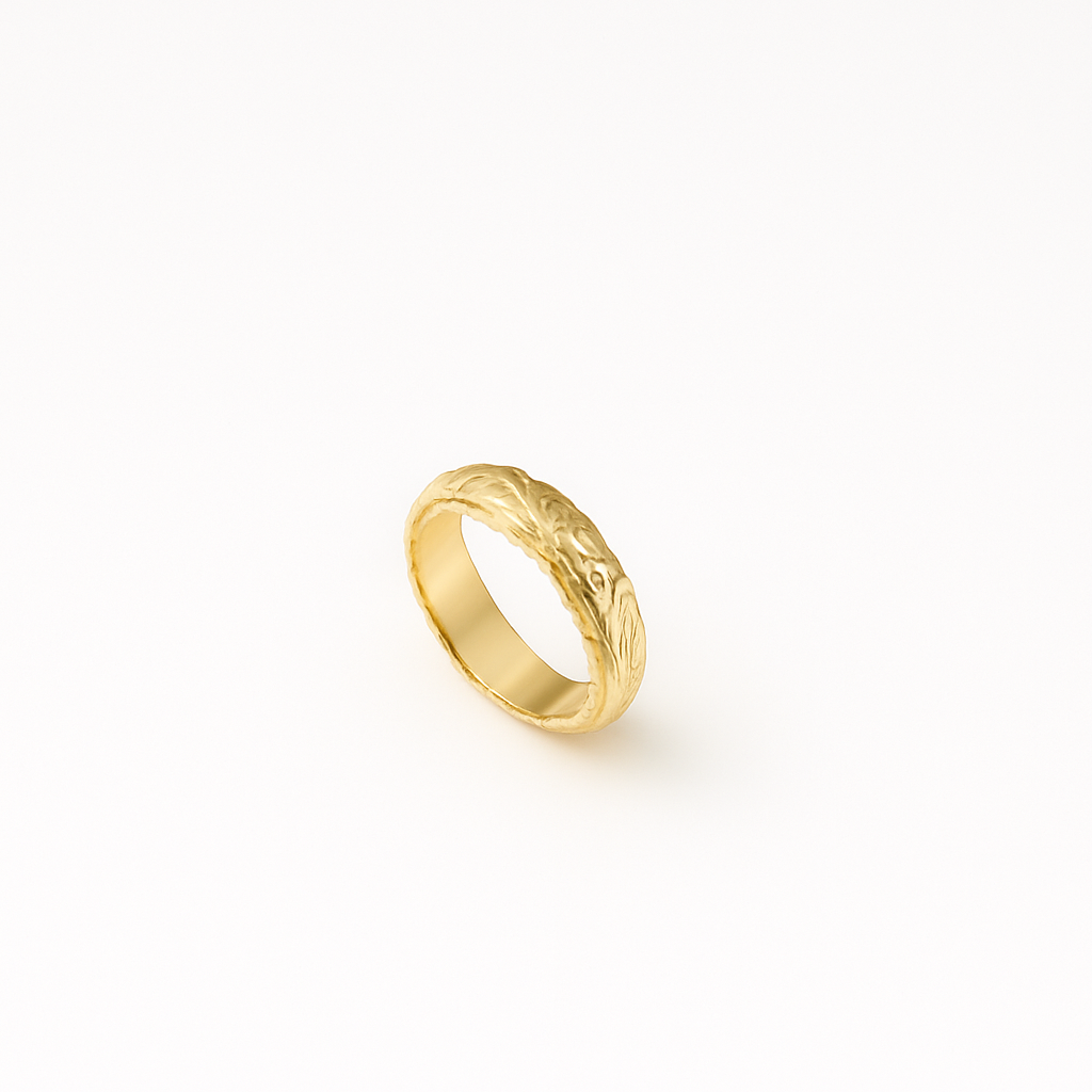Gold wedding band with intricate floral engraving on a white background. Elegant and timeless design, perfect for engagements or anniversaries.