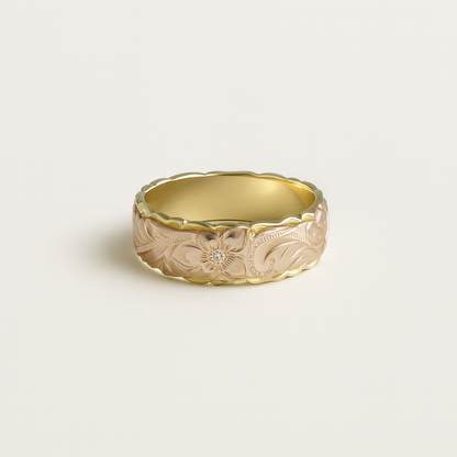 Gold ring with floral engraving on a light beige background
