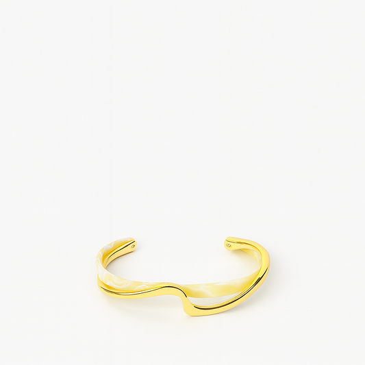 Gold cuff bracelet with a sleek, modern design on a white background. Elegant jewelry accessory, perfect for fashion-forward style enthusiasts.