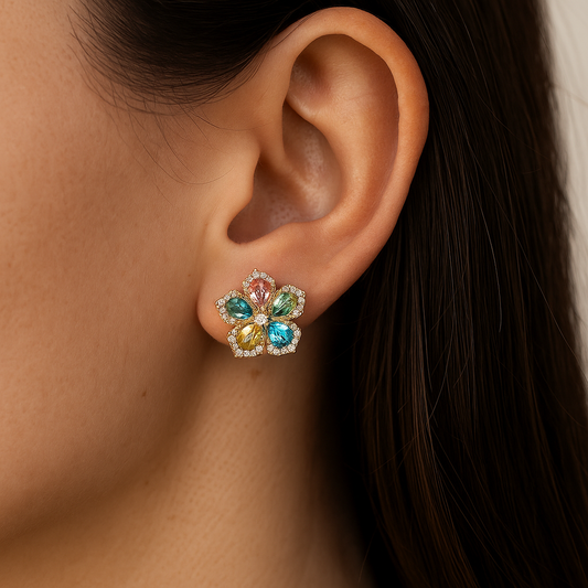 Multicolored gemstone earring worn on an ear with dark hair.