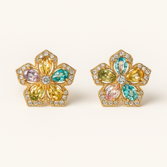 Pair of floral earrings with multicolored gemstones on a white background