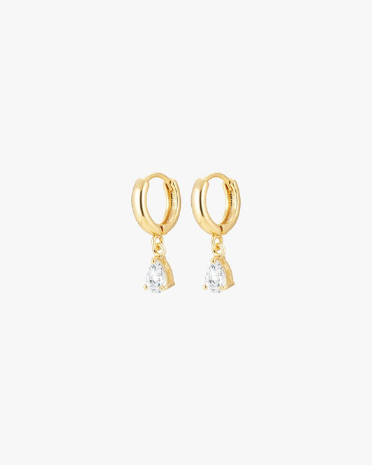 Gold hoop earrings with teardrop diamond pendants, elegant jewelry design, luxury fashion accessory, sparkling gemstones, minimalist style.