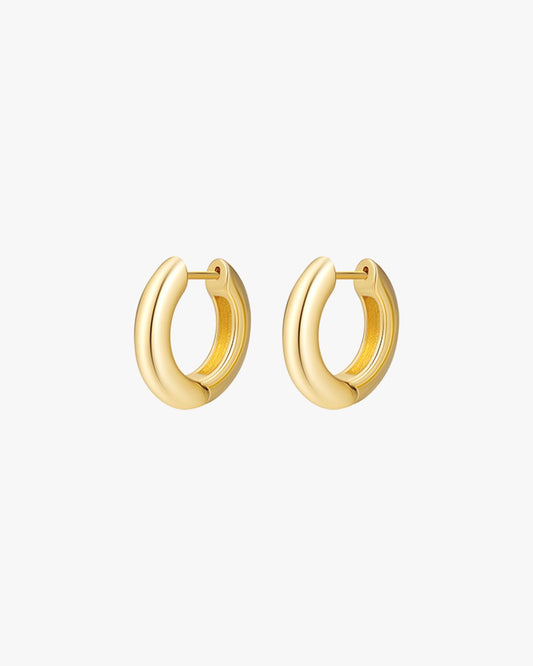 Gold hoop earrings on white background, minimalist jewelry, small round design, women's fashion accessories, elegant gold earrings, stylish hoops.