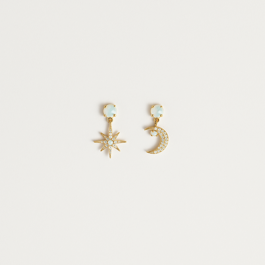 Gold star and moon earrings with crystal accents on a white background. Celestial jewelry, fashion accessories, elegant design.