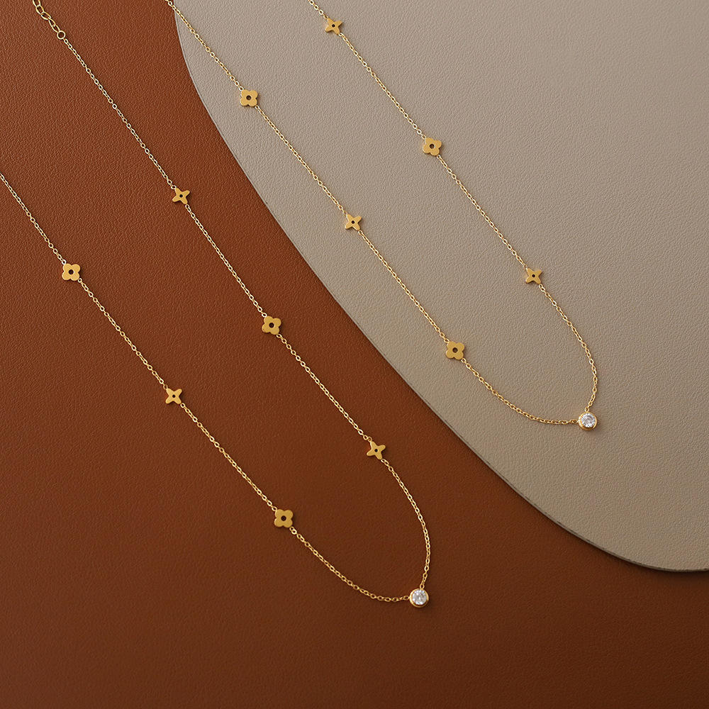 Gold necklace with star-shaped pendants on a brown and beige gradient background