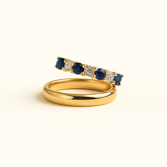 Gold ring with blue gemstones on a white background