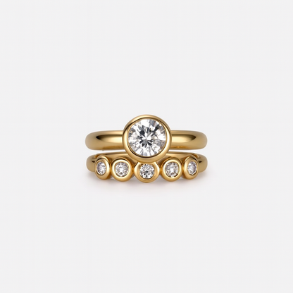 Gold ring with diamond on a light gray background