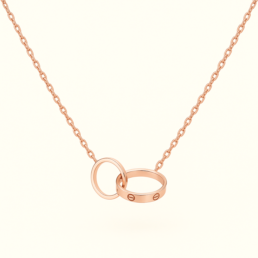 Rose gold necklace with interlocking rings pendant, featuring a delicate chain. Elegant jewelry piece, perfect for weddings or anniversaries.