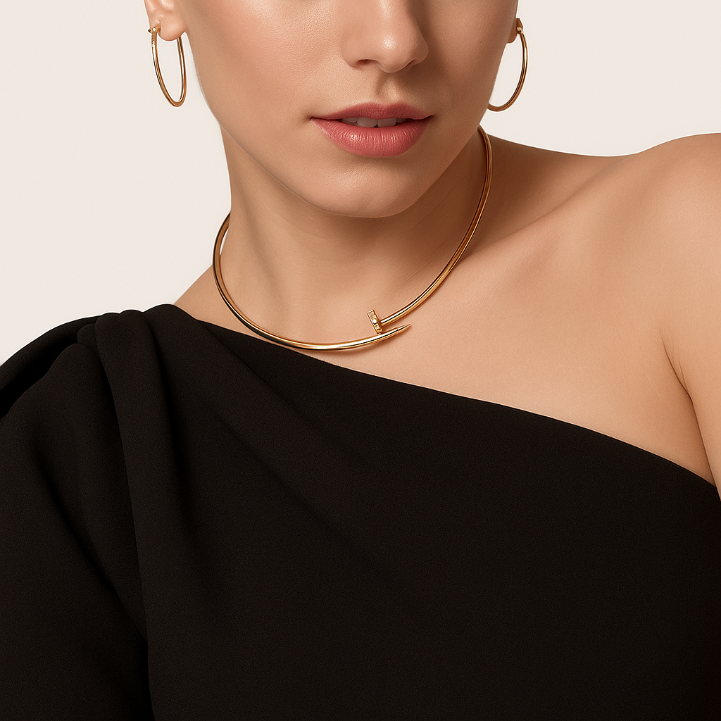 Elegant woman wearing a gold necklace and hoop earrings, dressed in a stylish black off-shoulder top. Fashion jewelry, chic style, modern elegance.