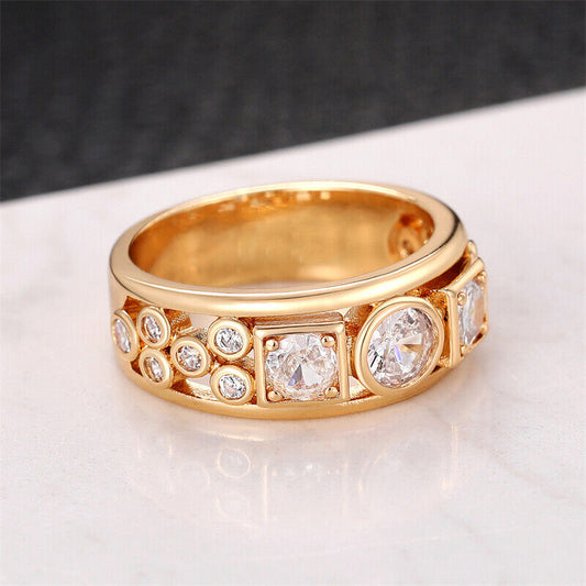 Gold ring with diamond accents on a light background