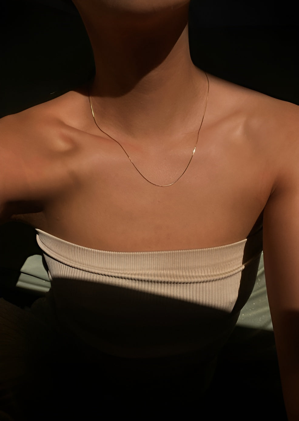 Necklace on a person with a dark background