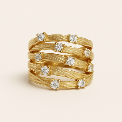 Gold ring with diamond stones on a beige background