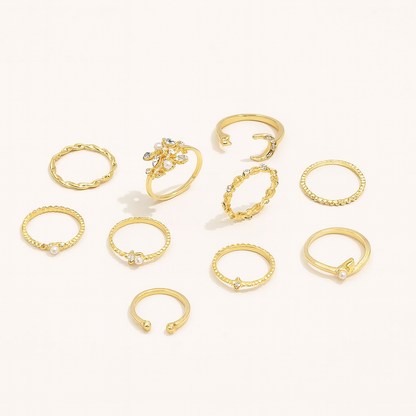 Elegant gold rings collection with intricate designs and gemstone accents, featuring stackable and adjustable styles on a light background.