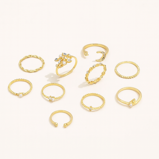 Elegant gold rings collection with intricate designs and gemstone accents, featuring stackable and adjustable styles on a light background.